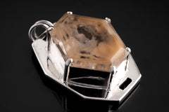 Faceted Madagascar Quartz pendant shown close-up with natural inclusions and polished sterling silver setting.