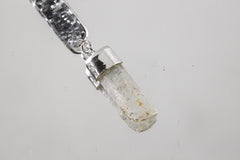 Close-up of Australian Aquamarine pendant showing pale blue crystal set into hammered sterling silver.