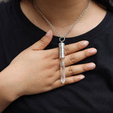 Australian Clear Quartz capsule pendant worn on a model with polished sterling silver body and crystal point base.