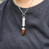 Brown Tourmaline Dravite capsule locket pendant shown worn on a model, with polished sterling silver and crystal point base.