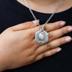 HexaFlame Ethiopian Opal pendant worn on chest with high-shine sterling silver and central Opal cabochon.