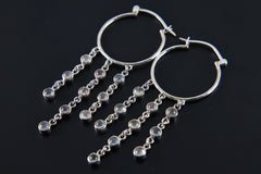 Cat Eye Moonstone hoop earring shown on a dark background with large silver hoop and cascading gemstone chains.