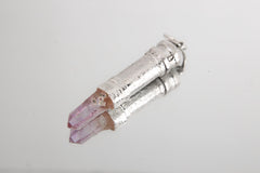 Vera Cruz Amethyst capsule pendant shown on white background with polished 925 sterling silver and raw crystal point.