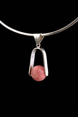 Rhodochrosite spinning pendant displayed on a choker as a polished sterling silver Heart Chakra necklace.