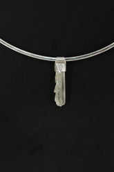 Skeletal Aquamarine Stack Pendant shown on black background with sterling silver cap and raw green-blue crystal body.