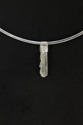 Skeletal Aquamarine Stack Pendant shown on black background with sterling silver cap and raw green-blue crystal body.