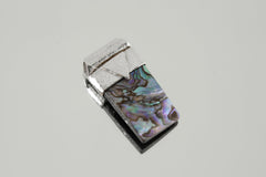 Mother of Pearl Stack Pendant shown on light background with iridescent nacre and organic textured silver cap.