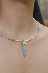 Lemurian Laser Aqua Aura Quartz Stack Pendant shown worn on the chest with sterling silver cap and aqua-blue crystal point.