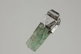 Small Terminated Aquamarine Stack Pendant shown on a light background with textured sterling silver cap and green-blue crystal.