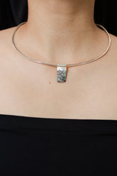 Mother of Pearl Stack Pendant shown worn on the chest with textured sterling silver cap and soft iridescent nacre.