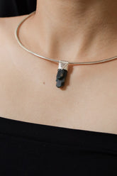 Blue Gem Apatite Stack Pendant shown worn on the chest with sterling silver cap and vivid blue-green crystal.