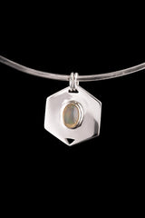 Ethiopian Opal hexagon pendant displayed on a choker against dark background with polished silver frame.