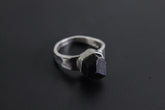 Handmade 925 sterling silver Black Tourmaline ring shown on a dark background, with raw black crystal and hammered silver band.