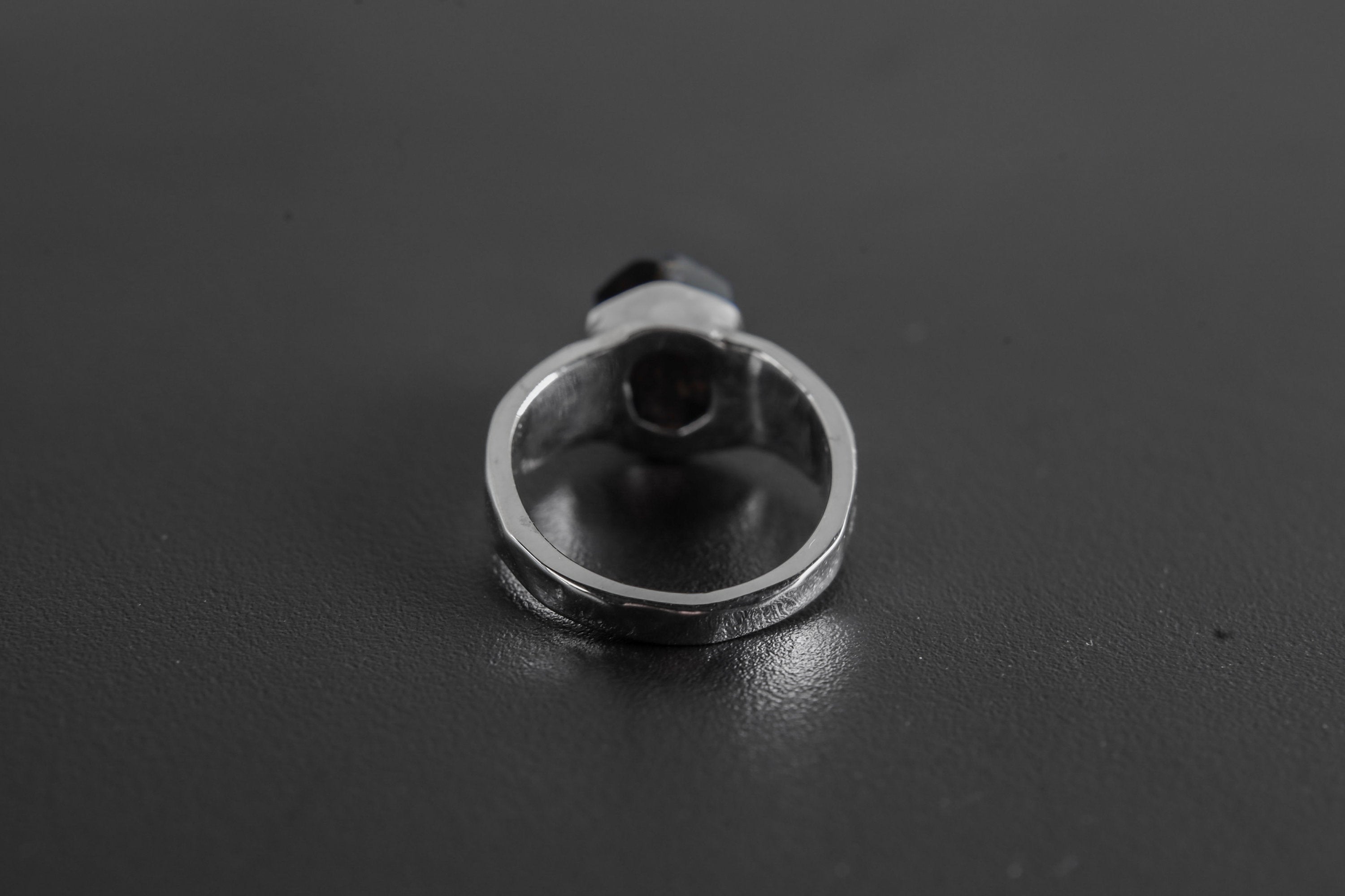 Back view of Black Tourmaline sterling silver ring showing the circular band and handmade hammered silver texture.