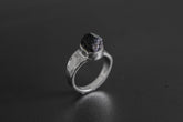 Handmade 925 sterling silver Black Tourmaline ring shown on a dark background, with raw black crystal and hammered silver band.