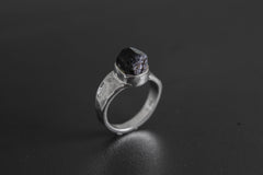Handmade 925 sterling silver Black Tourmaline ring shown on a dark background, with raw black crystal and hammered silver band.