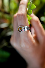 Amber Gaze Tiger Eye Ring shown worn outdoors with hammered sterling silver texture and warm brown gemstone.