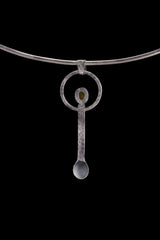 Peridot ritual spoon displayed on a choker, showing wearable talisman styling and oxidized sterling silver form.