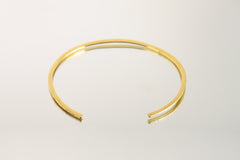 Textured gold-plated brass choker shown from the front, with open cuff design and clean handmade collar shape.