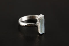Side view of Green Tourmaline silver ring showing hammered sterling silver band and upright gemstone setting.