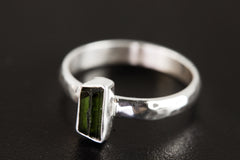 Side view of Green Tourmaline silver ring showing hammered sterling silver band and slim vertical gemstone setting.