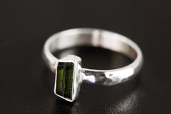 Side view of Green Tourmaline silver ring showing hammered sterling silver band and slim vertical gemstone setting.