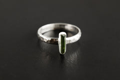 Green Tourmaline ring shown on a dark background, with polished 925 sterling silver band and vertical green stone setting.