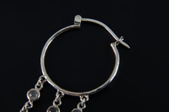 Detailed view of large Moonstone hoop earring showing sterling silver hoop fitting and dangling gemstone chains.