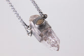 Vera Cruz Amethyst Ethiopian Opal Pendant shown on light background with oxidized sterling silver chain and crystal point.