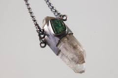Vera Cruz Amethyst Emerald Pendant shown on light background with raw Australian Emerald and clear Amethyst crystal.