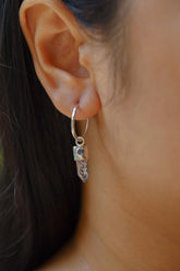 Vera Cruz Amethyst Opal hoop earrings shown worn on the ear, with compact sterling silver hoops and crystal dangles.