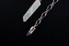 Charoite Angel Aura Quartz Amethyst pendant shown worn on a dark background with violet stones and high-shine silver.