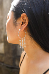 Cascading Cat Eye Moonstone hoop earring in polished 925 sterling silver shown worn on the ear with chain dangles.
