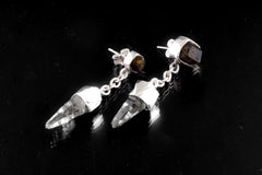Close view of sterling silver earrings showing Brown Dravite Tourmaline studs, Clear Quartz drops, and polished chain detail.