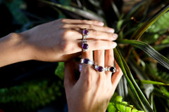 Harmonious Amethyst Essence Ring shown worn outdoors with round Amethyst gemstone and handmade silver band.