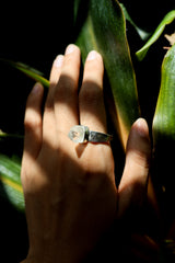 Cacoxenite Quartz point ring shown worn on the hand, with golden-brown inclusions and shiny hammered sterling silver band.