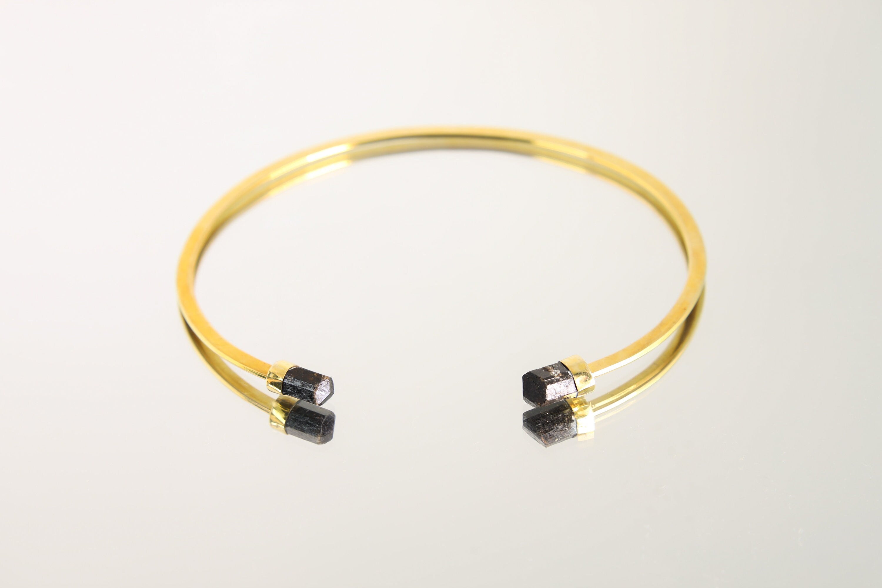Gold-plated brass open neck cuff with Brown Tourmaline crystal ends, shown as a minimalist pendant base choker.