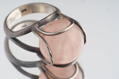 Close-up of Rose Quartz Floral Silver Ring showing organic silver wire petals around the soft pink cabochon.