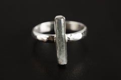 Aquamarine silver ring shown on a dark background, with polished 925 sterling silver band and vertical blue stone setting.