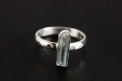 Green Tourmaline ring shown on a dark background, with polished 925 sterling silver band and vertical green gemstone setting.