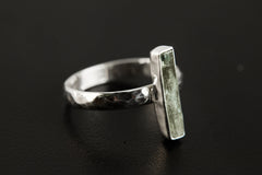 Side view of long square cut Aquamarine ring showing polished hammered silver band and slim gemstone setting.