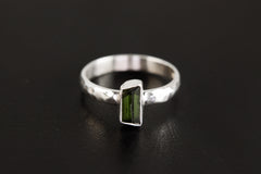 Green Tourmaline ring shown on a dark background, with polished 925 sterling silver band and vertical green stone setting.