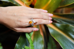 Red and Ethiopian Kyanite ring shown worn outdoors, with fiery red stone, blue-green Kyanite, and handmade silver setting.