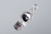 Black Tourmaline Watermelon Tourmaline pendant shown on a light background with polished sterling silver and specialty chain.