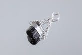 Black Tourmaline Eclipse pendant shown on white background with handmade sterling silver setting and chain.