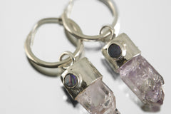 Close-up of Vera Cruz Amethyst and Opal hoop earrings showing claw-set crystals and polished sterling silver hoops.