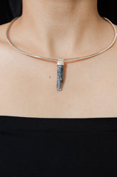 Kyanite Stack Pendant shown worn on the chest with sterling silver cap and blue bladed crystal.