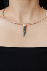 Kyanite Stack Pendant shown worn on the chest with sterling silver cap and blue bladed crystal.