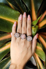 Rose Quartz Floral Silver Ring shown worn on hand with round pink gemstone and sculptural oxidized silver setting.