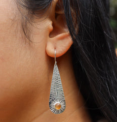 Silver Leaf Orange Agate earrings shown worn on the ear, with high-shine silver texture and warm earthy gemstone detail.